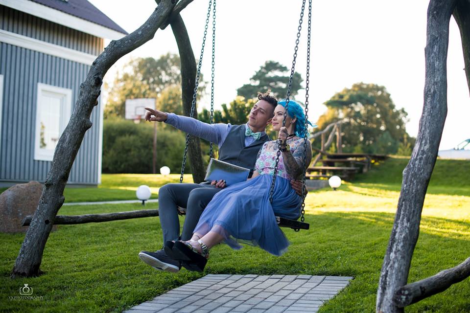 Romantic evening shot of the couple sharing a kiss under fairy lights.