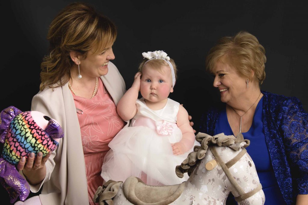 Cherished moment as the godparents pose with the baby, celebrating their role in the child's spiritual journey in port laoise