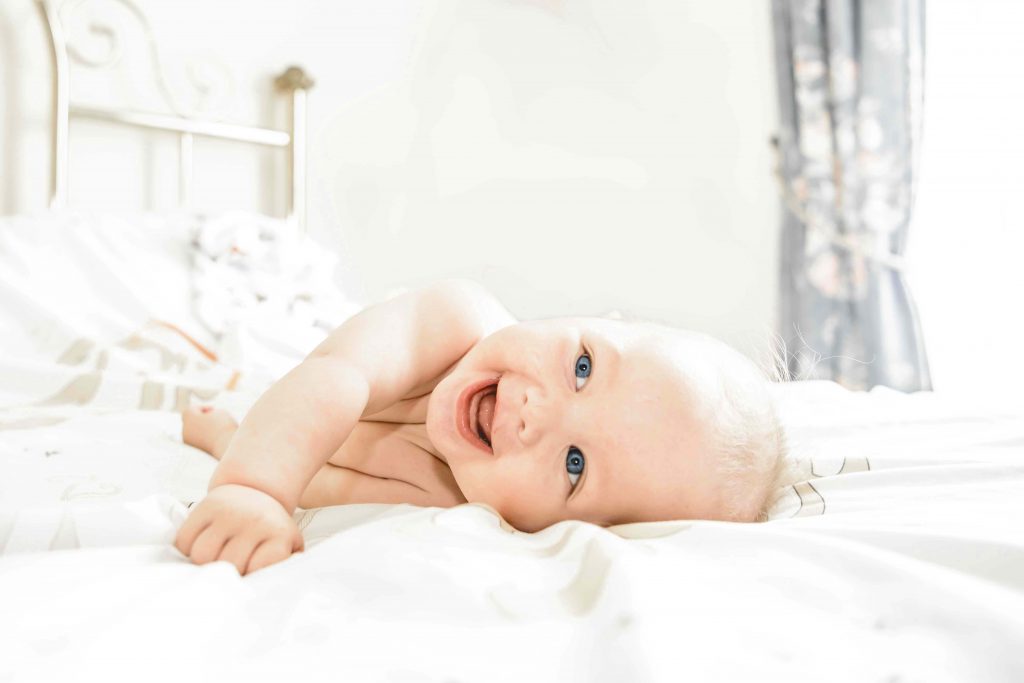 Close-up of the baby's christening gown, capturing the delicate details and significance.