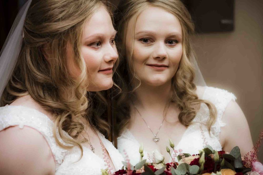 Intricate henna designs on the hands of a bride at a cultural celebration.