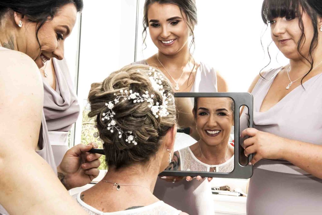 Bride and bridesmaids raising their glasses in a toast at a chic city wedding.