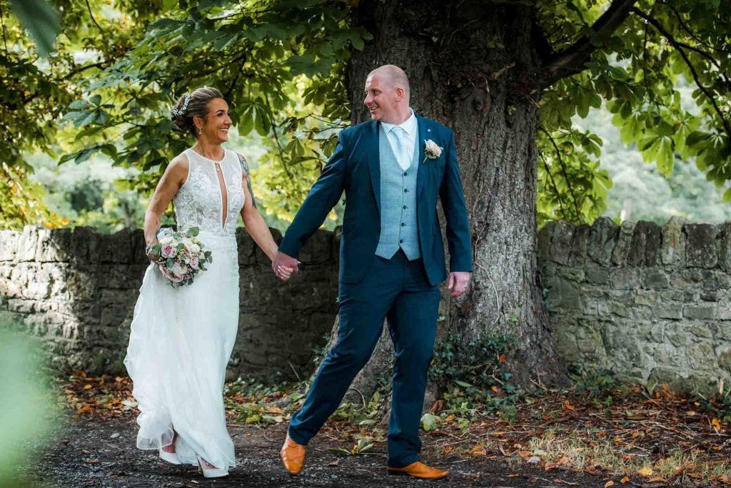 Epic aerial view of the couple surrounded by lush greenery in a garden ceremony.