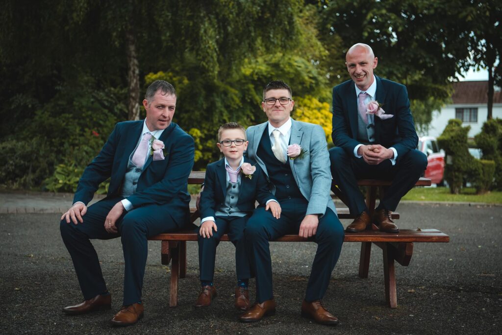 Groomsmen sharing a lighthearted moment while getting ready.