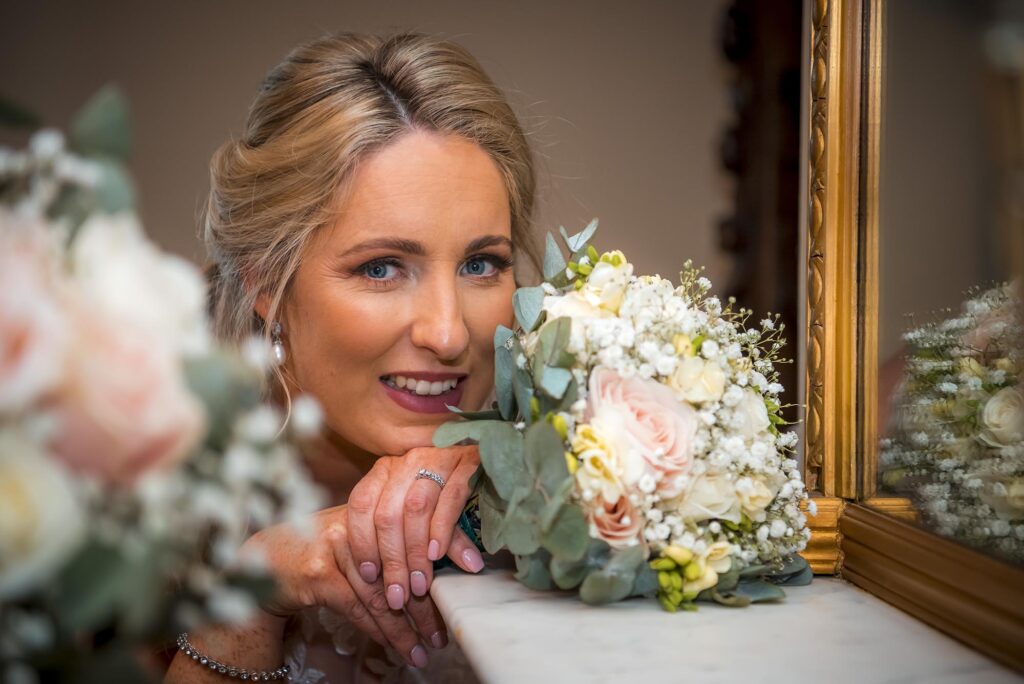 Close-up of the intricate lace details on the bride's elegant wedding gown.