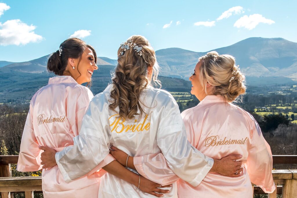 Bride and bridesmaids sharing laughter and joy while walking.