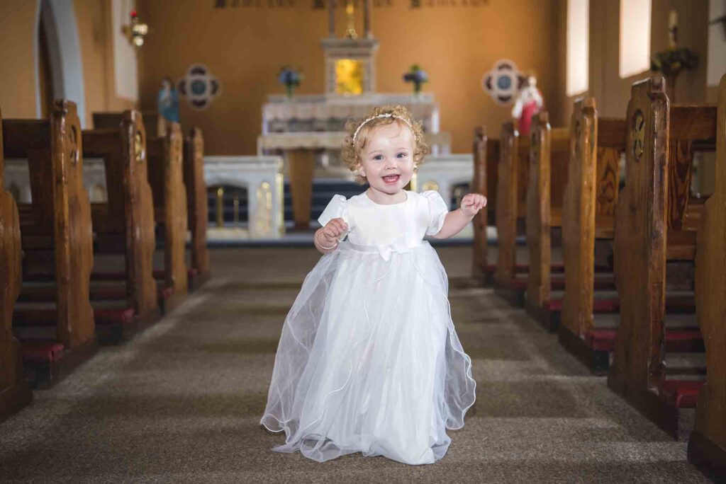 Baby receiving a heartfelt blessing during the christening ceremony.