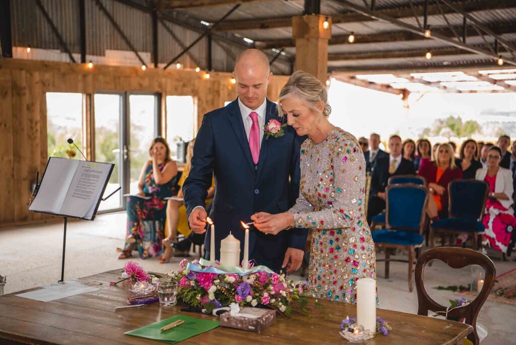 Elegant outdoor wedding ceremony with floral decorations.