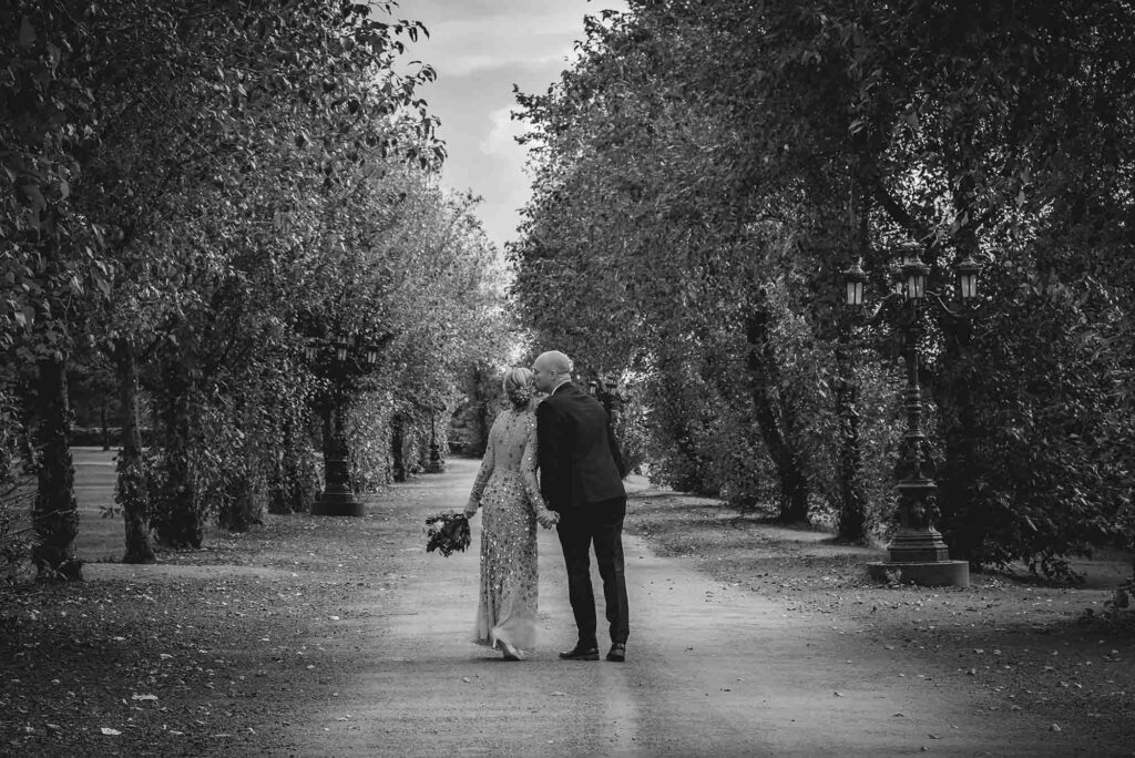 Silhouette of the couple against a fiery sunset on their beach wedding day.